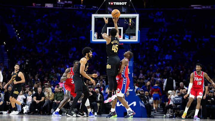 Jan 24, 2025; Philadelphia, Pennsylvania, USA; Cleveland Cavaliers guard Donovan Mitchell (45) shoots the ball against Philadelphia 76ers guard Tyrese Maxey (0) during the first quarter at Wells Fargo Center. Mandatory Credit: Bill Streicher-Imagn Images