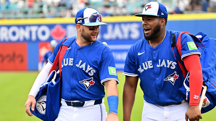 Feb 25, 2025; Dunedin, Florida, USA; Toronto Blue Jays shortstop Bo Bichette (11) and designated hitter Vladimir Guerrero Jr. (27) walk towards the dugout before a spring training game against the St. Louis Cardinals at TD Ballpark. Feb 25, 2025; Dunedin, Florida, USA; Toronto Blue Jays shortstop Bo Bichette (11) and designated hitter Vladimir Guerrero Jr. (27) walk towards the dugout before a spring training game against the St. Louis Cardinals at TD Ballpark.