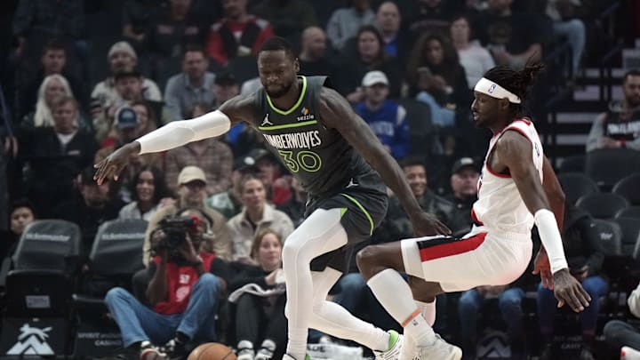 Nov 13, 2024; Portland, Oregon, USA; Minnesota Timberwolves power forward Julius Randle (30) collides with Portland Trail Blazers small forward Jerami Grant (9, right) during the first half at Moda Center. Mandatory Credit: Soobum Im-Imagn Images