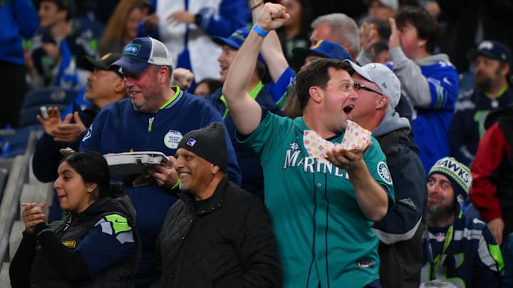 Oct 20, 2025; Seattle, Washington, USA; A fan wearing a Seattle Mariners jersey cheers prior to the game between the Houston Texans and the Seattle Seahawks at Lumen Field. Mandatory Credit: Steven Bisig-Imagn Images