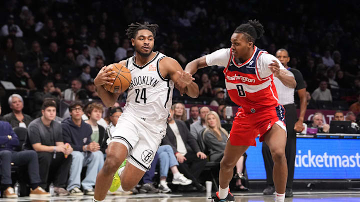 Oct 14, 2024; Brooklyn, New York, USA; Brooklyn Nets small guard Cam Thomas (24) drives the ball against Washington Wizards guard Bub Carrington (8) during the first half at Barclays Center. Mandatory Credit: Gregory Fisher-Imagn Images