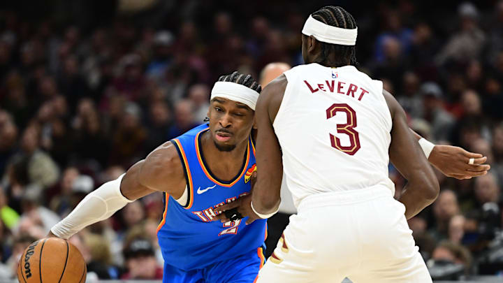 Jan 8, 2025; Cleveland, Ohio, USA; Oklahoma City Thunder guard Shai Gilgeous-Alexander (2) drives to the basket against Cleveland Cavaliers guard Caris LeVert (3) during the first half at Rocket Mortgage FieldHouse. Mandatory Credit: Ken Blaze-Imagn Images Jan 8, 2025; Cleveland, Ohio, USA; Oklahoma City Thunder guard Shai Gilgeous-Alexander (2) drives to the basket against Cleveland Cavaliers guard Caris LeVert (3) during the first half at Rocket Mortgage FieldHouse. Mandatory Credit: Ken Blaze-Imagn Images