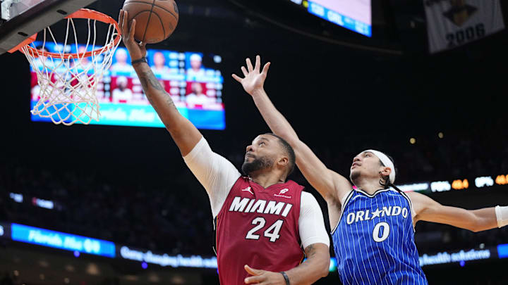 Jan 28, 2026; Miami, Florida, USA;  Miami Heat guard Norman Powell (24) goes up for a shot as Orlando Magic guard Anthony Black (0) follows on the play during the second half at Kaseya Center. Mandatory Credit: Jim Rassol-Imagn Images