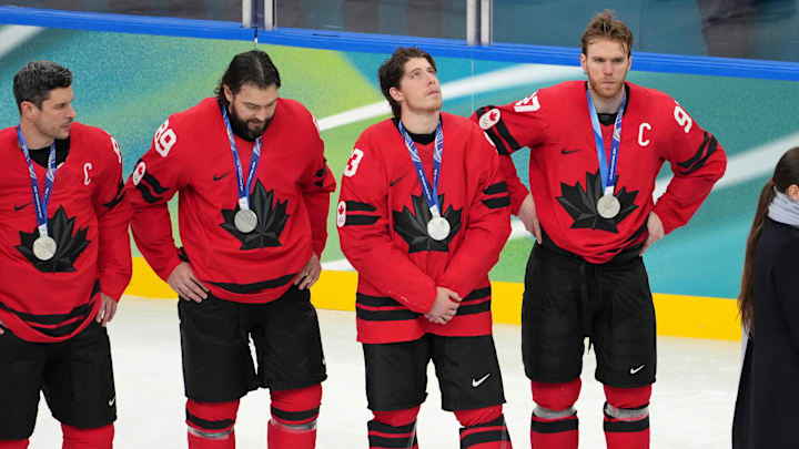 Feb 22, 2026; Milan, Italy; Connor McDavid of Canada (right) and teammates react after losing to the United States in the men's ice hockey gold medal game during the Milano Cortina 2026 Olympic Winter Games at Milano Santagiulia Ice Hockey Arena. Mandatory Credit: James Lang-Imagn Images Feb 22, 2026; Milan, Italy; Connor McDavid of Canada (right) and teammates react after losing to the United States in the men's ice hockey gold medal game during the Milano Cortina 2026 Olympic Winter Games at Milano Santagiulia Ice Hockey Arena. Mandatory Credit: James Lang-Imagn Images