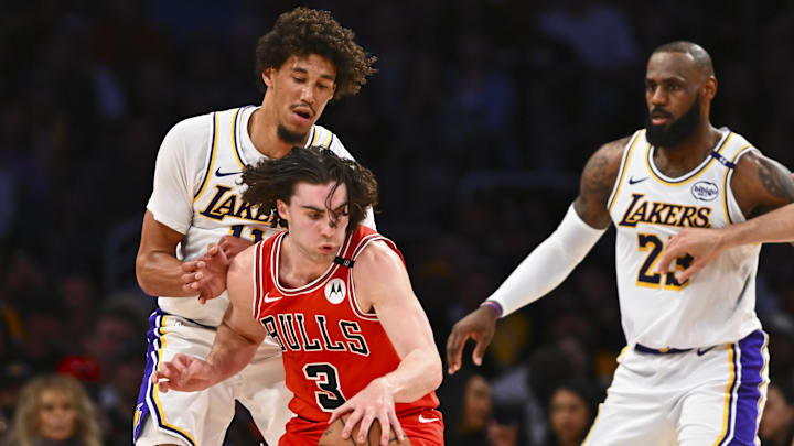 Mar 22, 2025; Los Angeles, California, USA; Chicago Bulls guard Josh Giddey (3) moves the ball against Los Angeles Lakers center Jaxson Hayes (11) and forward LeBron James (23) during the first half at Crypto.com Arena. Mandatory Credit: Jonathan Hui-Imagn Images