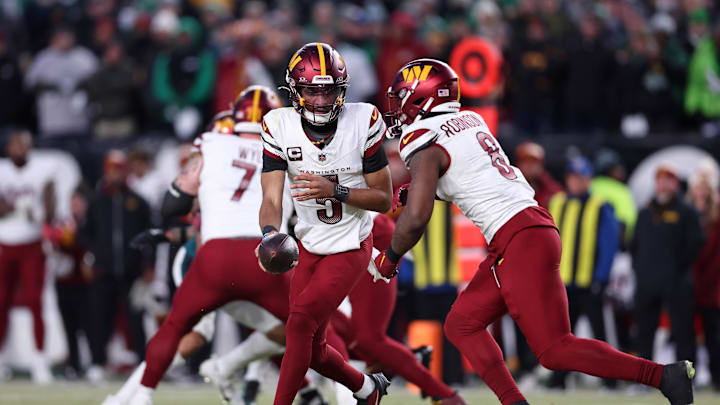 Washington Commanders quarterback Jayden Daniels hands off the ball to running back Brian Robinson Jr. Washington Commanders quarterback Jayden Daniels hands off the ball to running back Brian Robinson Jr.