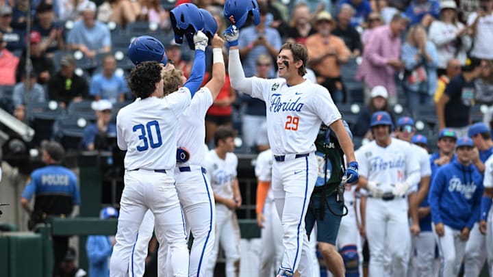 Jun 19, 2024; Omaha, NE, USA;  Florida Gators designated hitter Brody Donay (29) celebrates hitting a grand slam with right fielder Ashton Wilson (30) Mandatory Credit: Steven Branscombe-Imagn Images
