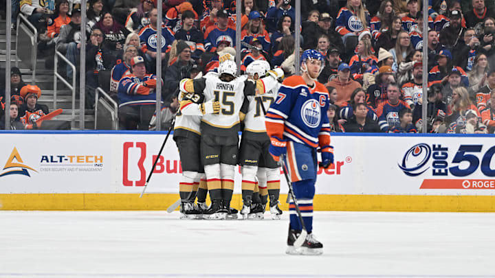 Dec 21, 2025; Edmonton, Alberta, CAN; Vegas Golden Knights right wing Mitch Marner (93) along with Golden Knights defenseman Noah Hanfin (15) celebrates a goal on Edmonton Oilers goalie Connor Ingram (39) as Oilers center Connor McDavid (97) skates past during the third period at Rogers Place. Mandatory Credit: Walter Tychnowicz-Imagn Images