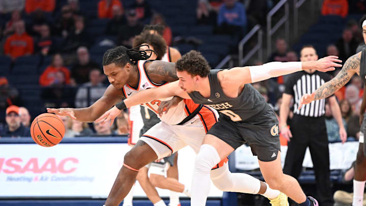 Jan 7, 2025; Syracuse, New York, USA; Syracuse Orange forward Jyare Davis (13) and Georgia Tech Yellow Jackets guard Lance Terry (0) go for a loose ball in the first half at the JMA Wireless Dome. Mandatory Credit: Mark Konezny-Imagn Images