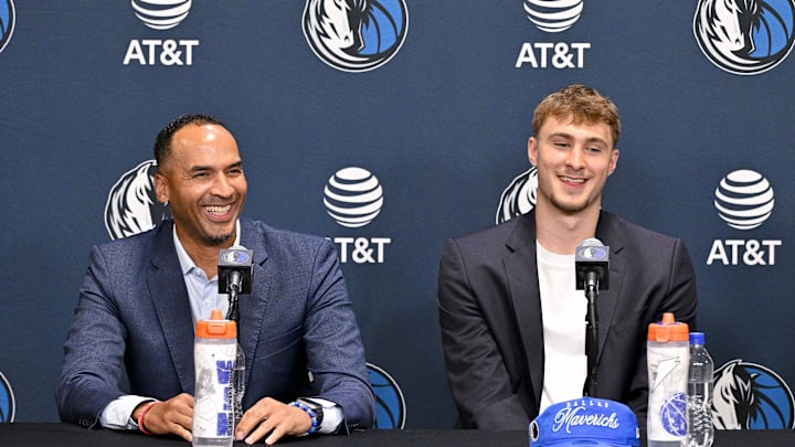 Jun 27, 2025; Dallas, TX, USA; Dallas Mavericks general manager Nico Harrison (left) looks on with Mavericks first overall pick Cooper Flagg (right) at a press conference at the Dallas Mavericks Practice Facility. Mandatory Credit: Jerome Miron-Imagn Images