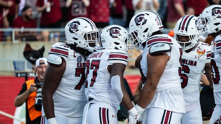 Dec 31, 2024; Orlando, FL, USA;  South Carolina Gamecocks running back Oscar Adaway III (27) celebrates his touchdown against the Illinois Fighting Illini in the third quarter at Camping World Stadium. Mandatory Credit: Jeremy Reper-Imagn Images