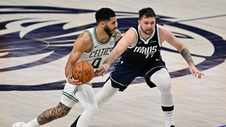 Jun 14, 2024; Dallas, Texas, USA; Boston Celtics forward Jayson Tatum (0) dribbles against Dallas Mavericks guard Luka Doncic (77) during the first half of game four of the 2024 NBA Finals at American Airlines Center. Mandatory Credit: Jerome Miron-Imagn Images