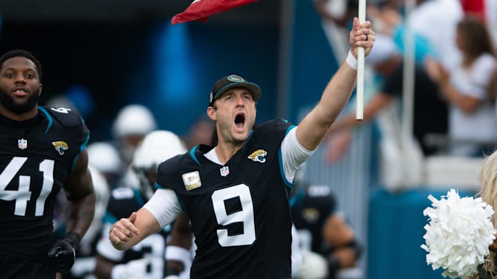 Nov 10, 2024; Jacksonville, Florida, USA;  Jacksonville Jaguars punter Logan Cooke (9) runs onto the field with the American flag before the game against the Minnesota Vikings at EverBank Stadium. Mandatory Credit: Jeremy Reper-Imagn Images