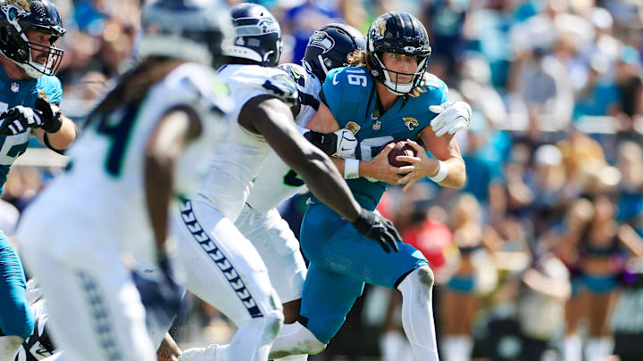 Jacksonville Jaguars quarterback Trevor Lawrence (16) is sacked by Seattle Seahawks linebacker DeMarcus Lawrence (0) during the second quarter of an NFL football matchup, Sunday, Oct. 12, 2025, at EverBank Stadium in Jacksonville, Fla. The Seahawks defeated the Jaguars 20-12.