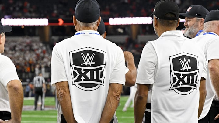 Dec 2, 2023; Arlington, TX, USA;  A view of the WWE wrestling logo on the sideline personnel before the game between the Texas Longhorns and the Oklahoma State Cowboys at AT&T Stadium. Mandatory Credit: Jerome Miron-Imagn Images