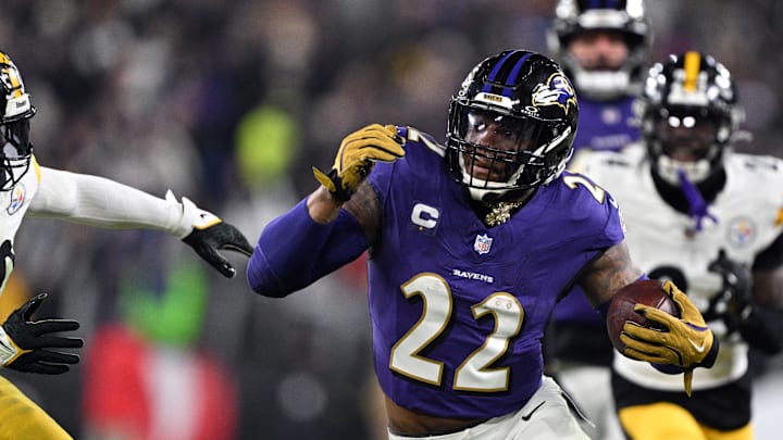 Jan 11, 2025; Baltimore, Maryland, USA; Baltimore Ravens running back Derrick Henry (22) runs against Pittsburgh Steelers linebacker Elandon Roberts (50) in the second quarter in an AFC wild card game at M&T Bank Stadium. Mandatory Credit: Tommy Gilligan-Imagn Images
