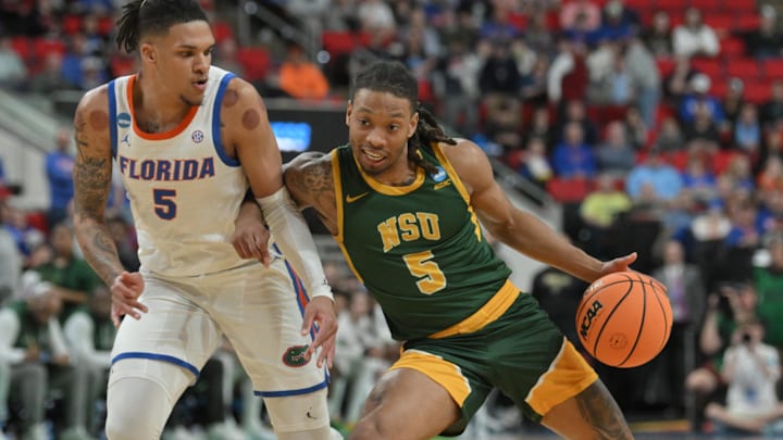 Florida Gators guard Will Richard (5) battles for the ball against Norfolk State Spartans guard Brian Moore Jr. (5). 