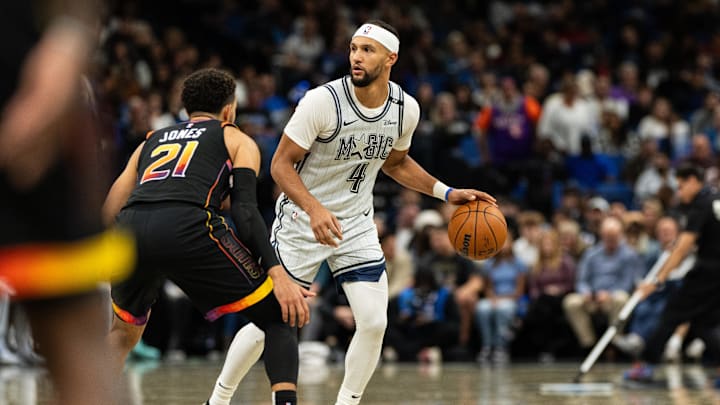Orlando Magic guard Jalen Suggs (4) dribbles the ball against Phoenix Suns guard Tyus Jones (21) in the second quarter at Kia Center.
