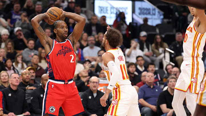 Jan 4, 2025; Inglewood, California, USA;  Los Angeles Clippers forward Kawhi Leonard (2) controls the ball against Atlanta Hawks guard Trae Young (11) during the first quarter at Intuit Dome. Mandatory Credit: Kiyoshi Mio-Imagn Images