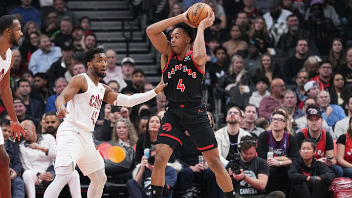 Feb 10, 2024; Toronto, Ontario, CAN; Toronto Raptors forward Scottie Barnes (4) controls the ball as Cleveland Cavaliers guard Donovan Mitchell (45) tries to defend during the first quarter at Scotiabank Arena . Mandatory Credit: Nick Turchiaro-Imagn Images