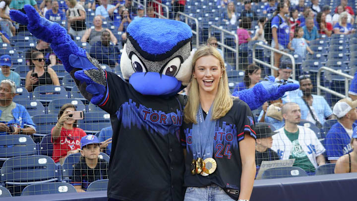 Multiple gold medal winning Canadian Olympian Summer McIntosh poses with the Toronto Blue Jays mascot Ace before throwing out the ceremonial first pitch against the Los Angeles Angels at Rogers Centre on Aug 23. Multiple gold medal winning Canadian Olympian Summer McIntosh poses with the Toronto Blue Jays mascot Ace before throwing out the ceremonial first pitch against the Los Angeles Angels at Rogers Centre on Aug 23.