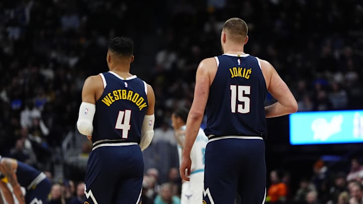 Feb 20, 2025; Denver, Colorado, USA; Denver Nuggets guard Russell Westbrook (4) and center Nikola Jokic (15) during the first quarter against the Charlotte Hornets at Ball Arena. Mandatory Credit: Ron Chenoy-Imagn Images
