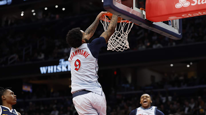 Dec 7, 2024; Washington, District of Columbia, USA; Washington Wizards forward Justin Champagnie (9) dunks the ball as Denver Nuggets forward Peyton Watson (8) and Wizards guard Bub Carrington (8) look on in the fourth quarter at Capital One Arena. Mandatory Credit: Geoff Burke-Imagn Images