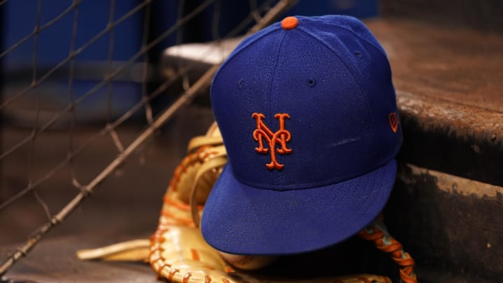 Aug 5, 2021; Miami, Florida, USA; A detailed view of the cap and mitt of New York Mets first baseman Pete Alonso (not pictured) on the dugout steps prior the the game against the Miami Marlins at loanDepot park. Mandatory Credit: Jasen Vinlove-USA TODAY Sports