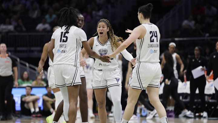  Golden State Valkyries guard Veronica Burton (22), talks to guard Tiffany Hayes (15),  forward Cecilia Zandalasini (24) and others against the Seattle Storm.