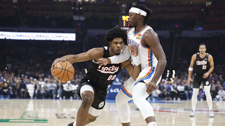 Nov 20, 2024; Oklahoma City, Oklahoma, USA; Portland Trail Blazers guard Scoot Henderson (00) drives down the court against Oklahoma City Thunder guard Luguentz Dort (5) during the first quarter at Paycom Center. Mandatory Credit: Alonzo Adams-Imagn Images