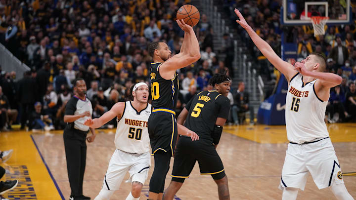 Golden State Warriors guard Stephen Curry (30) makes a three point shot over Denver Nuggets center Nikola Jokic (15) in the third quarter during game five of the first round for the 2022 NBA playoffs at Chase Center. Mandatory Credit: Cary Edmondson-Imagn Images Golden State Warriors guard Stephen Curry (30) makes a three point shot over Denver Nuggets center Nikola Jokic (15) in the third quarter during game five of the first round for the 2022 NBA playoffs at Chase Center. Mandatory Credit: Cary Edmondson-Imagn Images