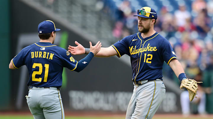 May 14, 2025; Cleveland, Ohio, USA; Milwaukee Brewers third baseman Caleb Durbin (21) and first baseman Rhys Hoskins (12) celebrate after the Brewers beat the Cleveland Guardians at Progressive Field. Mandatory Credit: Ken Blaze-Imagn Images