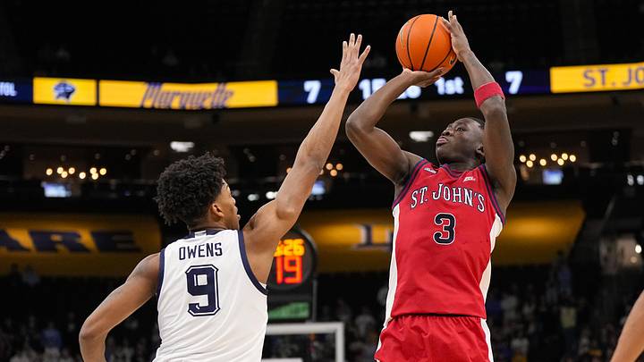 Feb 18, 2026; Milwaukee, Wisconsin, USA;  St. John's Red Storm guard Joson Sanon (3) shoots against Marquette Golden Eagles forward Damarius Owens (9) during the first half at Fiserv Forum. 