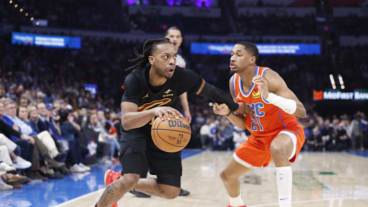 Jan 16, 2025; Oklahoma City, Oklahoma, USA; ]Cleveland Cavaliers guard Darius Garland (10) drives around Oklahoma City Thunder guard Aaron Wiggins (21) during the second quarter at Paycom Center. Mandatory Credit: Alonzo Adams-Imagn Images