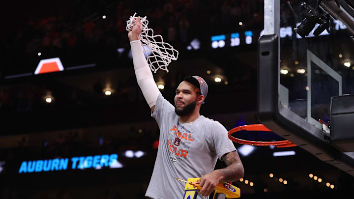 Mar 30, 2025; Atlanta, GA, USA; Auburn Tigers forward Johni Broome (4) cuts down the net after winning the South Regional final of the 2025 NCAA tournament against the Michigan State Spartans at State Farm Arena. Mandatory Credit: Brett Davis-Imagn Images