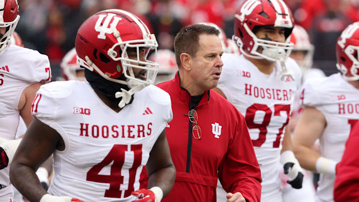 Nov 23, 2024; Columbus, Ohio, USA;  Indiana Hoosiers head coach Curt Cignetti runs with his team before the game against the Ohio State Buckeyes at Ohio Stadium. Mandatory Credit: Joseph Maiorana-Imagn Images