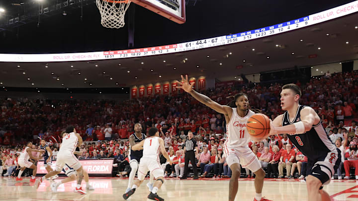 Feb 21, 2026; Houston, Texas, USA;  Arizona Wildcats forward Ivan Kharchenkov (8) inbounds the pass against Houston Cougars forward Joseph Tugler (11) in the second half at Fertitta Center. Mandatory Credit: Thomas Shea-Imagn Images