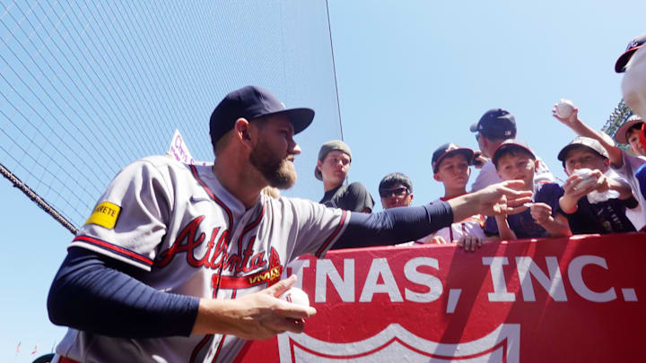 Apr 8, 2026; Anaheim, California, USA; Atlanta Braves pitcher Dylan Lee (52) signs autographs during the game against the Los Angeles Angels at Angel Stadium. Mandatory Credit: Kirby Lee-Imagn Images