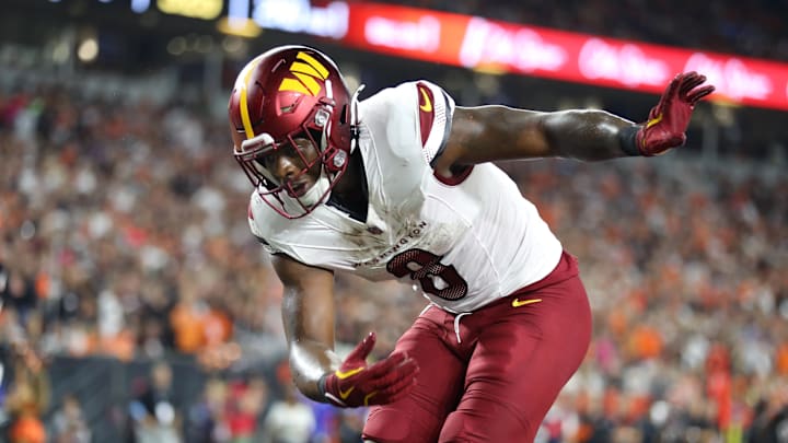 Washington Commanders running back Brian Robinson Jr. celebrates a touchdown.