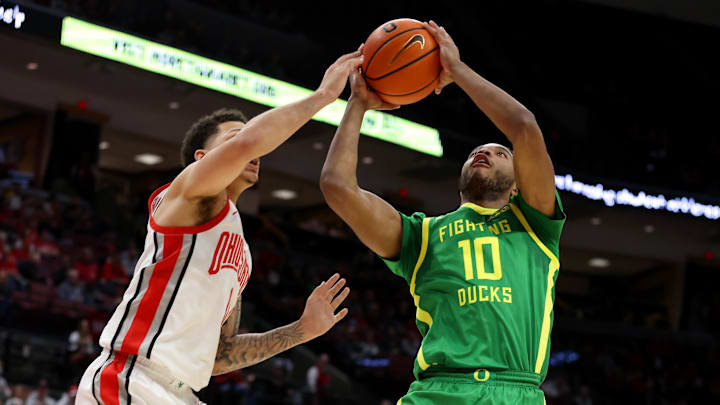 Jan 9, 2025; Columbus, Ohio, USA;  Oregon Ducks forward Kwame Evans Jr. (10) shoots the ball over Ohio State Buckeyes guard John Mobley Jr. (0) during the first half at Value City Arena. Mandatory Credit: Joseph Maiorana-Imagn Images