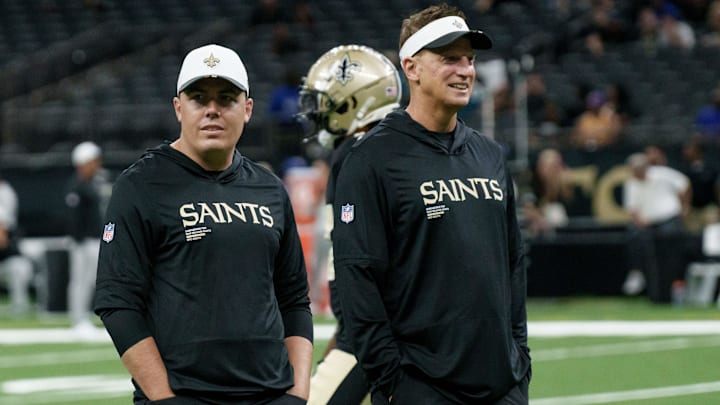 Aug 17, 2025; New Orleans, Louisiana, USA; New Orleans Saints offensive coordinator Doug Nussmeier  talks to New Orleans Saints head coach Kellen Moore, left, before a game against the Jacksonville Jaguars at Caesars Superdome. Mandatory Credit: Matthew Hinton-Imagn Images