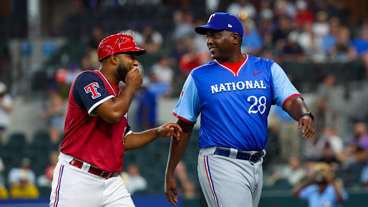 Jul 13, 2024; Arlington, TX, USA;  National League Future  coach Darren Oliver (r) laughs with American League Future coach Elvis Andrus during the game during the Major league All-Star Futures game at Globe Life Field.  Mandatory Credit: Kevin Jairaj-Imagn Images
