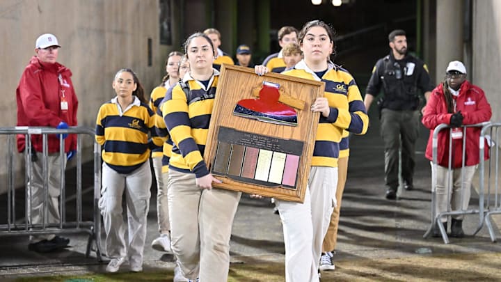 Members of the Cal axe committee carry the Axe onto the field at Stanford in 2023