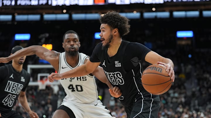 Mar 4, 2025; San Antonio, Texas, USA;  Brooklyn Nets forward Cameron Johnson (2) dribbles past San Antonio Spurs forward Harrison Barnes (40) in the second half at Frost Bank Center. Mandatory Credit: Daniel Dunn-Imagn Images