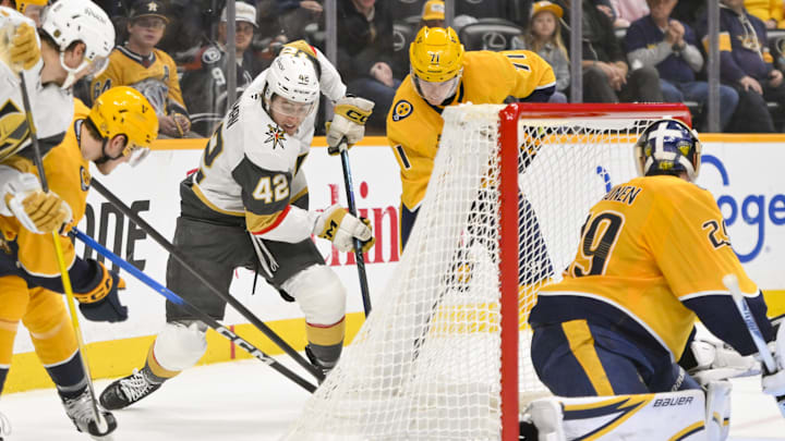 Mar 21, 2026; Nashville, Tennessee, USA;  Vegas Golden Knights right wing Braeden Bowman (42), Nashville Predators defenseman Brady Skjei (76) and right wing Matthew Wood (71) battle for the puck behind the net during the third period at Bridgestone Arena. Mandatory Credit: Steve Roberts-Imagn Images