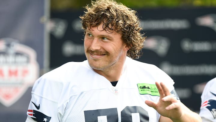 Jul 29, 2022; Foxborough, MA, USA; New England Patriots offensive lineman Cole Strange (50) walks onto the field before training camp at Gillette Stadium. Mandatory Credit: Brian Fluharty-Imagn Images