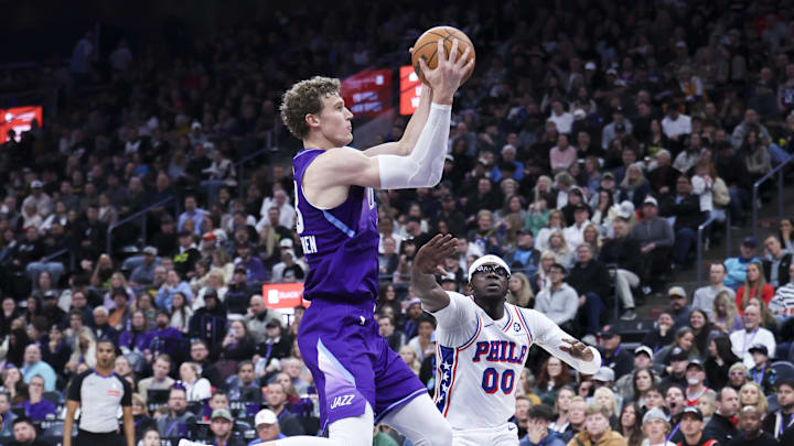 Dec 28, 2024; Salt Lake City, Utah, USA; Utah Jazz forward Lauri Markkanen (23) rebounds the ball against Philadelphia 76ers guard Reggie Jackson (00) during the third quarter at Delta Center. Mandatory Credit: Rob Gray-Imagn Images