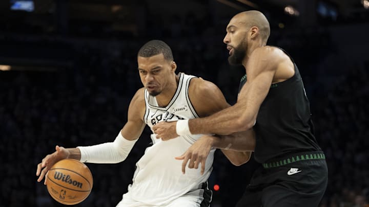 May 8, 2026; Minneapolis, Minnesota, USA; San Antonio Spurs forward Victor Wembanyama (1) dribbles past Minnesota Timberwolves center Rudy Gobert (27) in the first half during game three of the second round of the 2026 NBA Playoffs at Target Center. Mandatory Credit: Jesse Johnson-Imagn Images