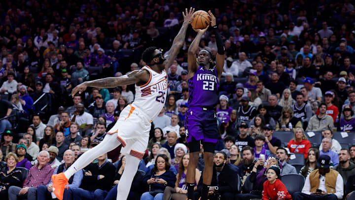 Dec 22, 2023; Sacramento, California, USA; Sacramento Kings guard Keon Ellis (23) shoots the ball against Phoenix Suns forward Nassir Little (25) during the fourth quarter at Golden 1 Center. Mandatory Credit: Sergio Estrada-Imagn Images