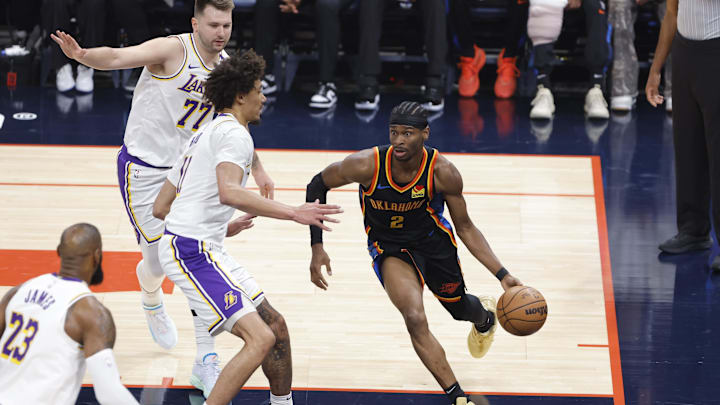 Apr 6, 2025; Oklahoma City, Oklahoma, USA; Oklahoma City Thunder guard Shai Gilgeous-Alexander (2) drives around Los Angeles Lakers center Jaxson Hayes (11) during the first quarter at Paycom Center. Mandatory Credit: Alonzo Adams-Imagn Images Apr 6, 2025; Oklahoma City, Oklahoma, USA; Oklahoma City Thunder guard Shai Gilgeous-Alexander (2) drives around Los Angeles Lakers center Jaxson Hayes (11) during the first quarter at Paycom Center. Mandatory Credit: Alonzo Adams-Imagn Images
